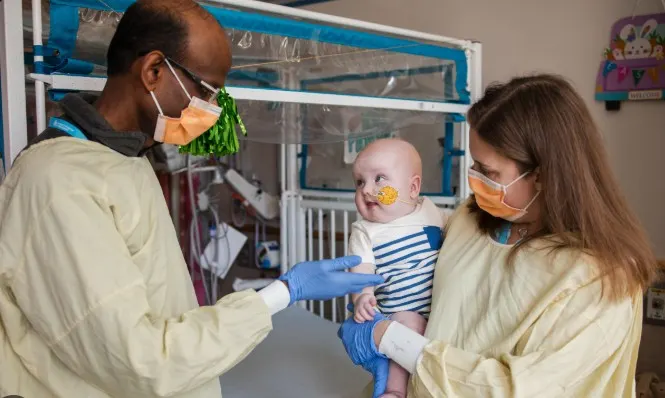 Dr Munsunuru with his infant patient